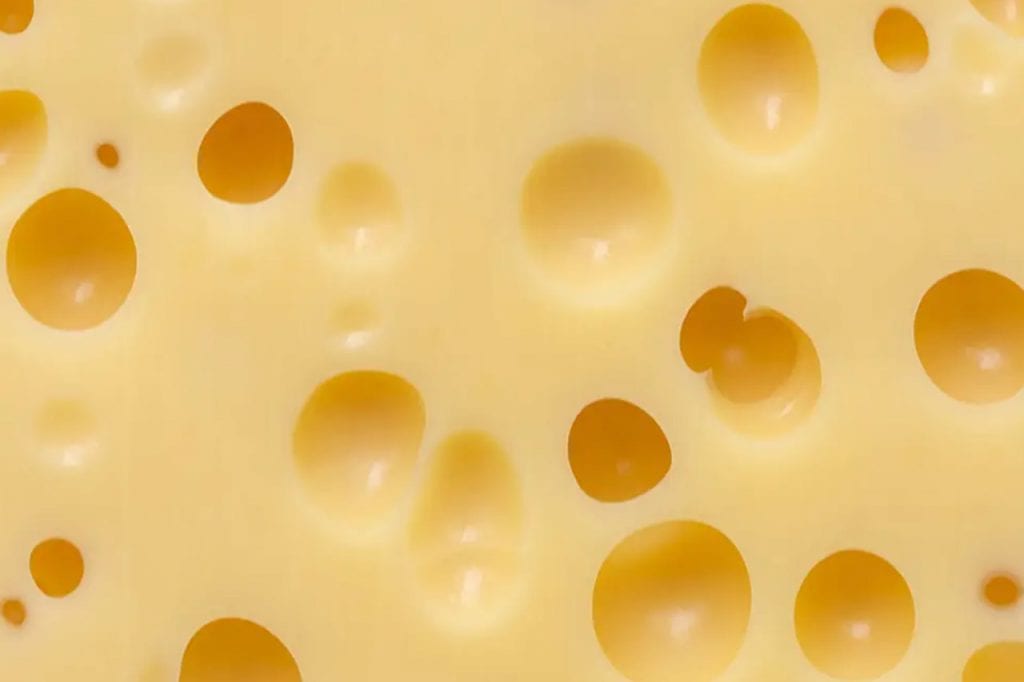 Skąd się biorą dziury w serze żółtym?